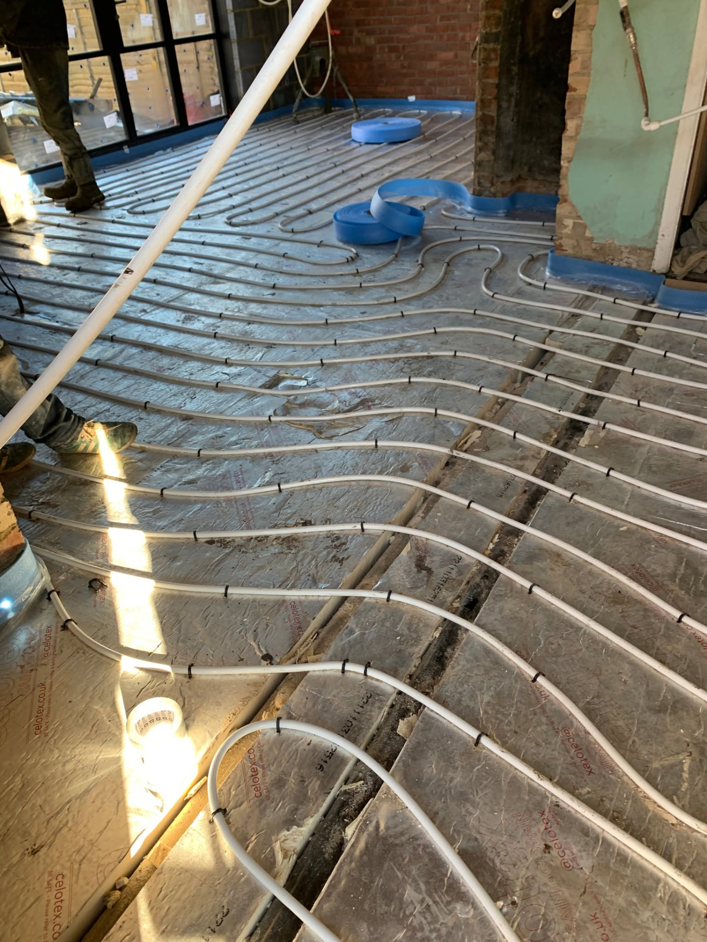 Underfloor heating pipe loops laid across a floor