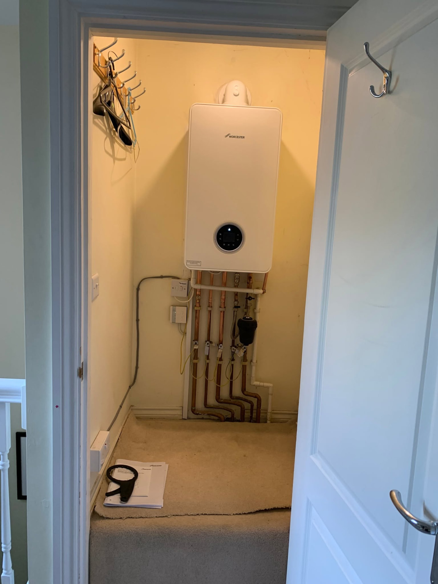 New boiler neatly installed inside a kitchen cupboard