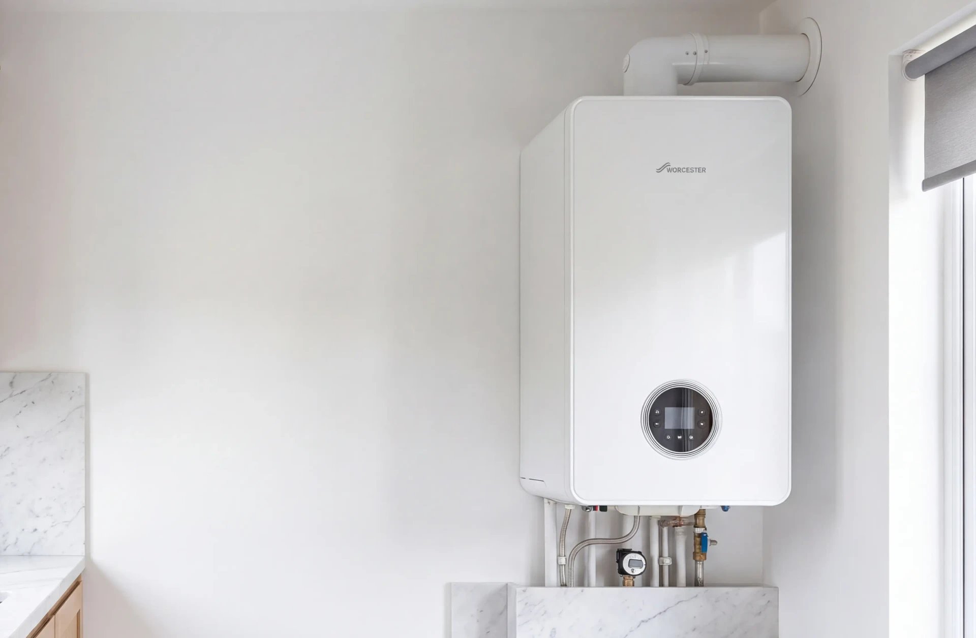 New white Worcester combi boiler on a white kitchen wall
